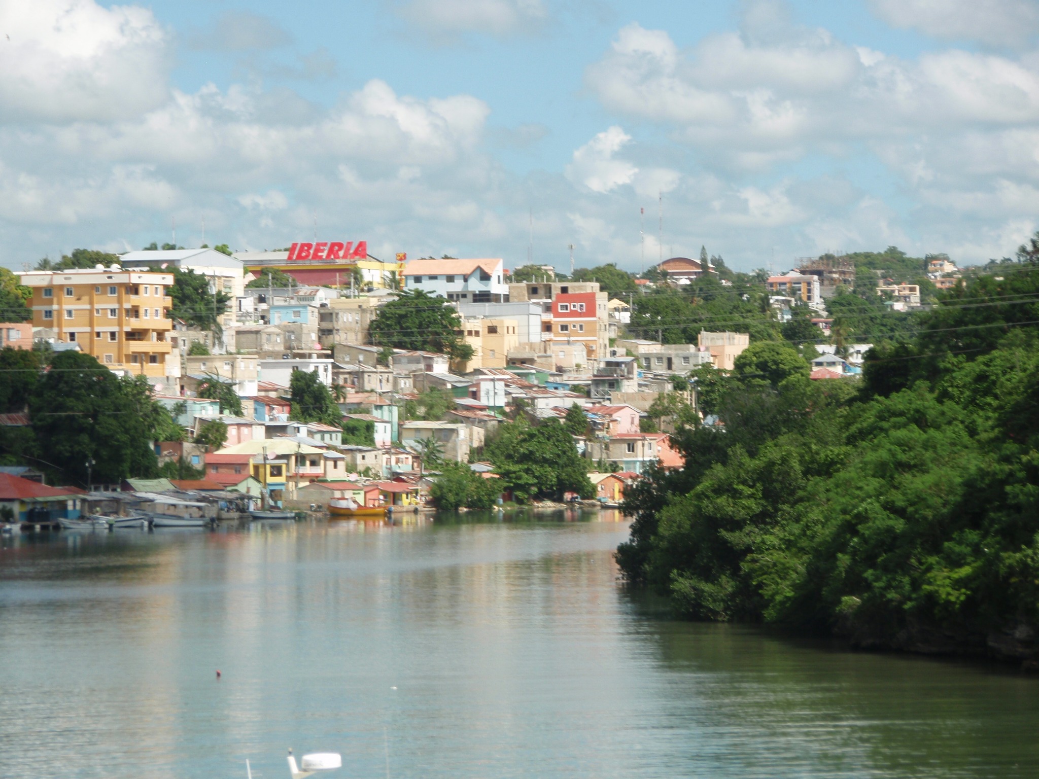 A colorful hillside community reflected in calm Caribbean water